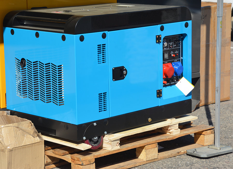 a blue and black generator sitting on a pallet