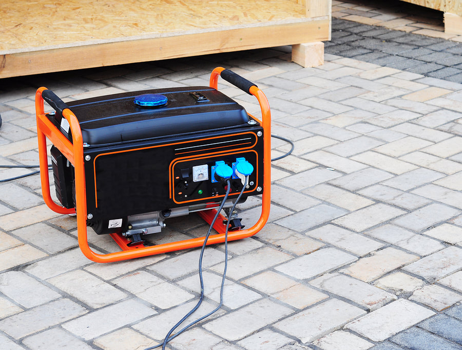 an orange and black portable generator on a brick patio